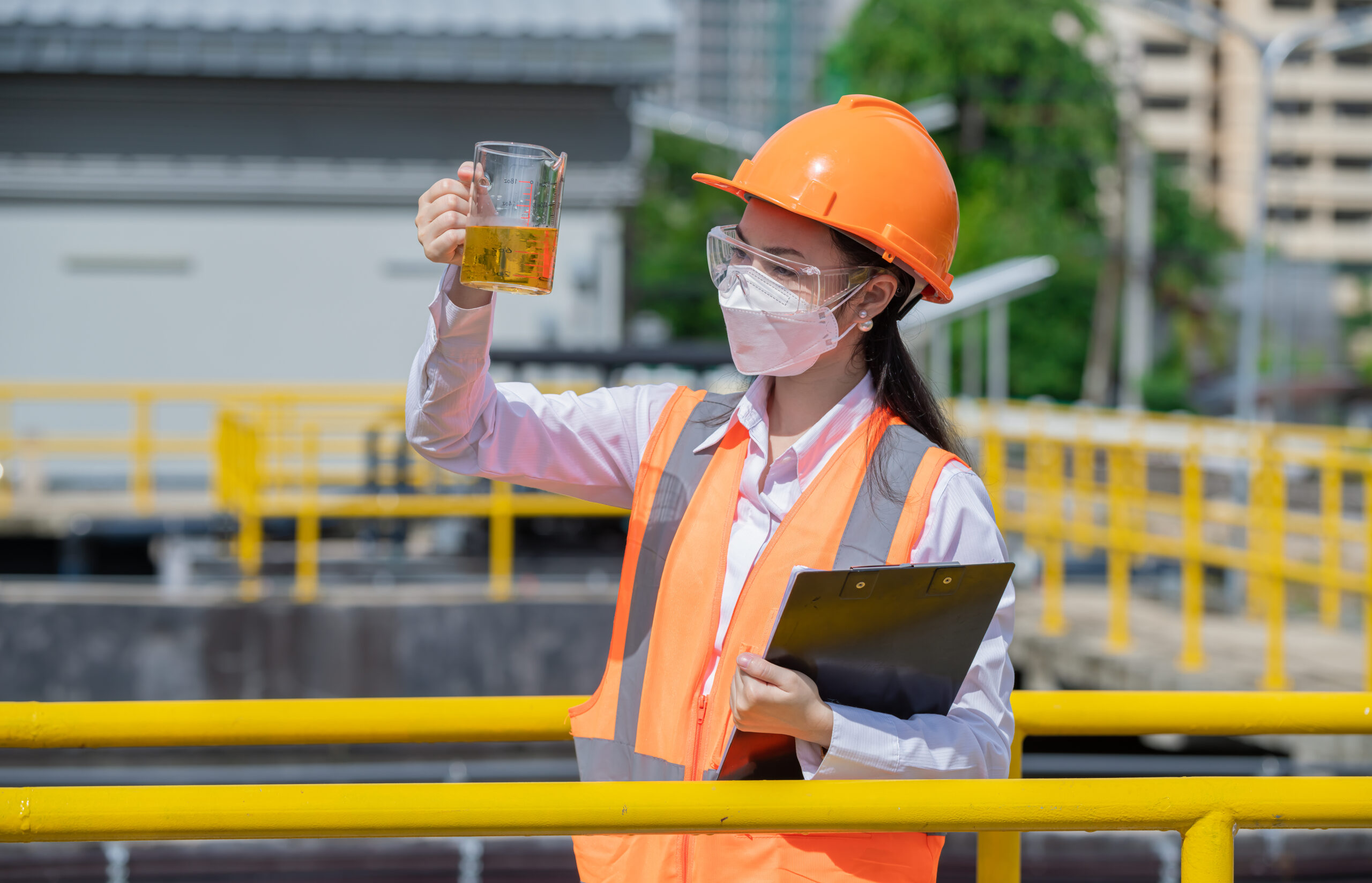 engineer-take-water-from-wastewater-treatment-pond-2023-04-04-22-20-50-utc